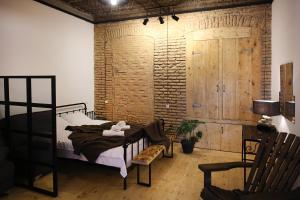 a bedroom with a bed and a wooden wall at Chrono Room in Tbilisi City