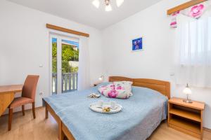a bedroom with a bed with a tray of food on it at Villas Rab Palit in Rab
