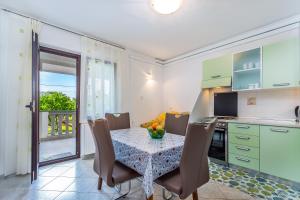 a kitchen and dining room with a table and chairs at Garden paradise App in Sveti Vid-Miholjice