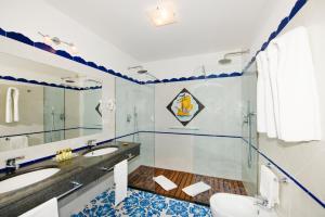 a bathroom with a sink and a toilet at Hotel Savoia in Positano
