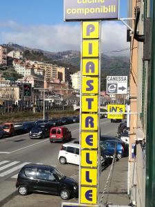 a street scene with cars and a street sign at Your Home in Genova in Genoa