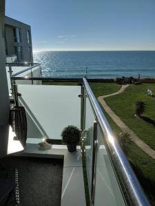 a view of the ocean from the balcony of a house at 23 Seagate Court in East Wittering