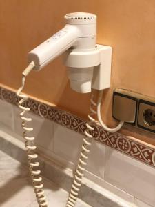 
a blow dryer that is in a bathroom at Hotel Rey Chindasvinto in Covarrubias
