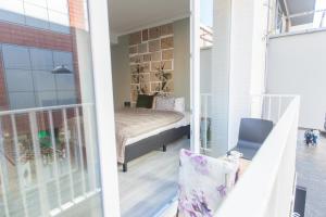 a view of a balcony with a bed in a room at Smartflats - Leuven in Leuven