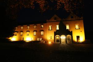 a large building with lights in front of it at night at Annamult Country House Estate in Kilkenny