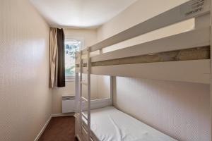 a bedroom with two bunk beds and a window at Residence Le Sepia - maeva Home in Avoriaz