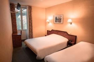 a hotel room with two beds and a window at Hôtel Neptune Place d'Italie in Paris