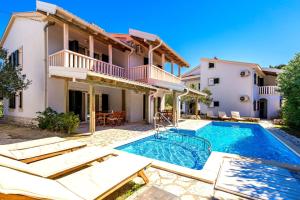 a villa with a swimming pool and a house at Villas Rab Palit in Rab