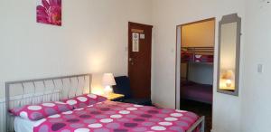 a bedroom with a bed with a polka dot sheet at Hotel Avano - Pleasure Beach in Blackpool