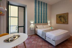 A bed or beds in a room at Mythos Holidays