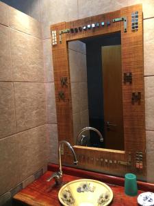 a bathroom with a sink and a mirror at Santa Teresita en el monte in Santa Teresita +50 photos