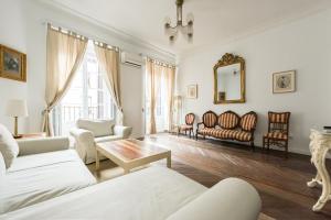 a living room with white furniture and a mirror at Apartamentos Madrid Centro W in Madrid