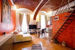 a living room with a couch and a spiral staircase at OLD SQUARE APARTMENTS 3 in Timişoara