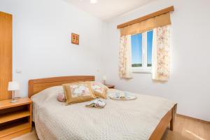 a bedroom with a bed with a tray of food on it at Villas Rab Palit in Rab