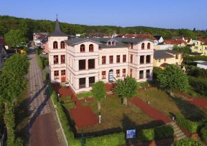 an aerial view of a large white house at Villa Maria Wohnung 02 in Ostseebad Koserow