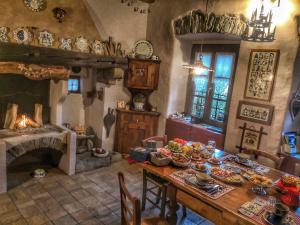 a dining room with a table and a fireplace at B&B Dove Comincia la Bella Italia in Beura