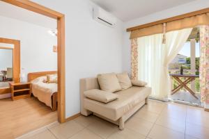 a living room with a couch and a bed at Villas Rab Palit in Rab