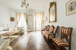 a living room with a couch and chairs and a table at Apartamentos Madrid Centro W in Madrid