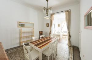 a white dining room with a table and chairs at Apartamentos Madrid Centro W in Madrid