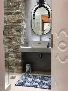 a bathroom with a sink and a mirror at Porfyra Luxury Guesthouse in Kalavrita +56 photos