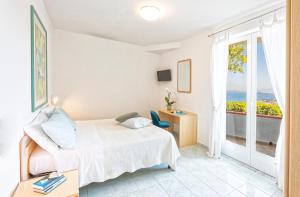 Postel nebo postele na pokoji v ubytování Paradise Relais Villa Janto'