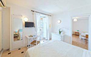 En eller flere senge i et værelse på Paradise Relais Villa Janto'
