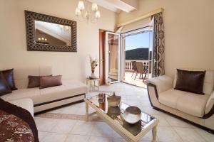 a living room with two couches and a table at Madalena's Apartment in Razáta