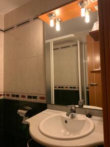 a bathroom with a sink and a mirror at Hostal Monasterio de Rueda in Sástago