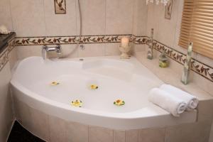 a bathroom with a white sink with flowers on it at Madalena's Apartment in Razáta +75 photos