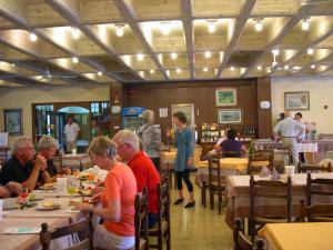 a group of people sitting at tables in a restaurant at Residence Miralago Rooms & Apartments in Manerba del Garda