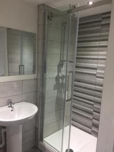 a bathroom with a shower and a sink at Liverpool townhouse in Liverpool