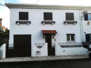 a white house with a fence in front of it at Room Dream Beato in Lisbon