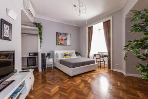 a bedroom with a bed and a living room at Athena Guest House in Rome