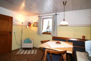 a dining room with a table and a window at Haus Wiesenrand in Berchtesgaden