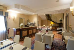 a restaurant with a table and chairs and a staircase at Hotel Davanzati in Florence