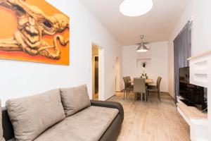 a living room with a couch and a dining room at Jagger House in Novalja