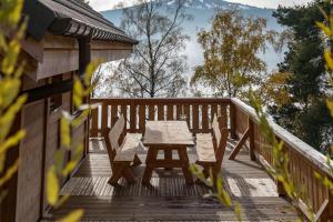a wooden deck with a table and chairs on it at La Datcha de Liza in Metzeral