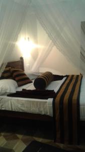 A bed or beds in a room at Sun View Resort Kithalella