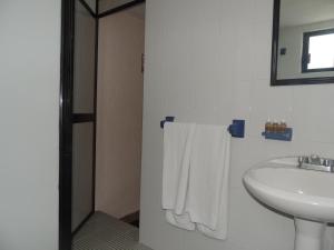 a bathroom with a sink and a mirror and towels at Hotel Kyoto in Puebla +39 photos