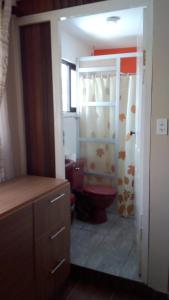 a bathroom with a toilet and a sink in it at Apartamento Golden Junior in Cochabamba