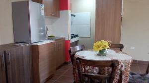 a kitchen with a table with a vase of yellow flowers on it at Apartamento Golden Junior in Cochabamba