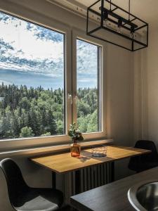 a table in a room with a large window at Stylový apartmán přímo u lanovky, vlastní garážové stání in Janske Lazne