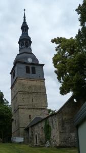 a tower with a clock on top of a building at Ferienhaus Scheper in Bad Frankenhausen