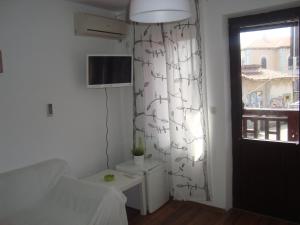 a living room with a couch and a window at Deep Blue Guest House in Sozopol