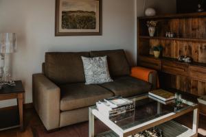 a living room with a couch and a coffee table at La Casa del Muro in Sos del Rey Católico