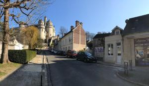 a city street with cars parked on the side of the road at Villa Napoléon in Pierrefonds