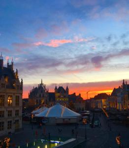 a view of a city at sunset at Margaretha's Room in Mechelen +6 photos