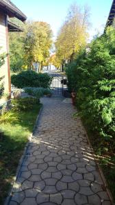 a stone walkway in a yard with a gate at Vila Marta in Druskininkai