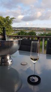 a glass of white wine sitting on a table at 18 on Tides End in Knysna