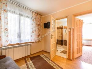 a living room with a door and a window at Pokoje u Katarzyny in Rzepiska